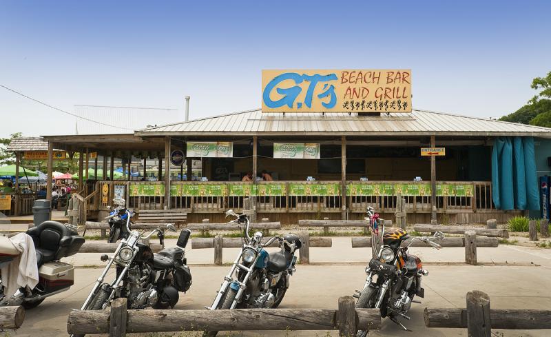 Motorcycles parked out front of GT's on the Beach 
